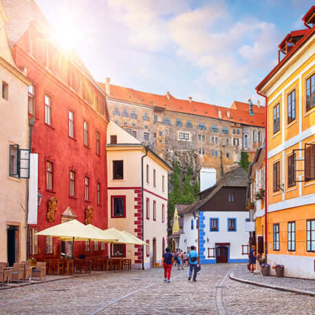 Cesky Krumlov, Czech Republic. Ancient street with old houses. Evening sunset with sunlight.